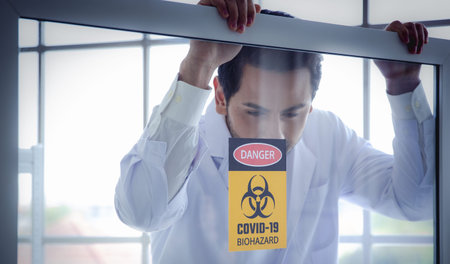 A scientist laboratory window warning danger covid biohazard pandemic safety quarantine scientist laboratory looking through window covid biohazard