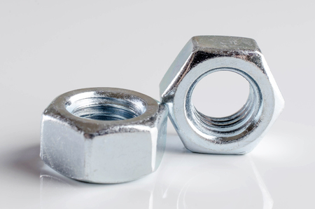 Close up of screw nuts on white background.