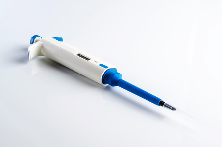 Automatic pipette on white table. Laboratory equipment.の写真素材