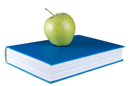 Blue book with green apple on white background. Back to school.の写真素材