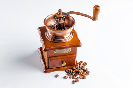 Coffee grinder with roasted coffee beans isolated on white background.の写真素材