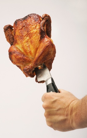 Roasted Chicken on a Knife.の写真素材