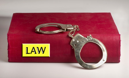 Law-book and handcuffs.