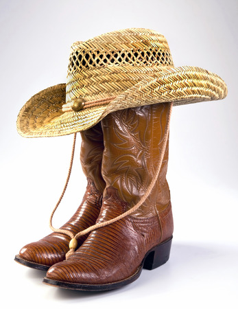 Cowboy lizard skin boots and straw hat.の写真素材