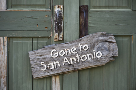 Gone to San Antonio,Texas sign on old green door.の写真素材