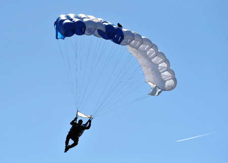Parachutist in the deep blue sky.の写真素材