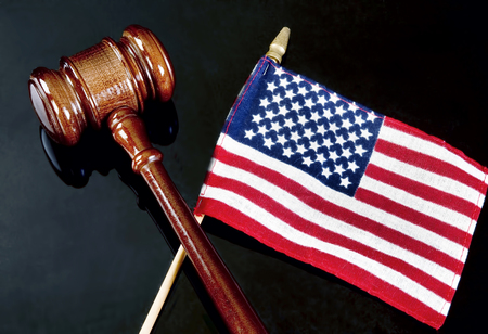Gavel and American flag on dark background.の写真素材