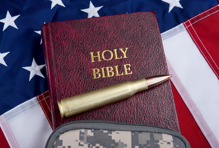 Religion and peace with fifty caliber bullet , bible and American flag .の写真素材
