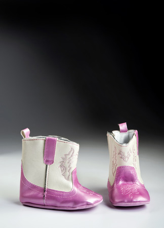 Pink baby boots with room for your type.の写真素材