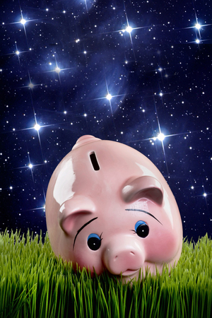 Pink piggy bank at dusk with room for your type.の写真素材