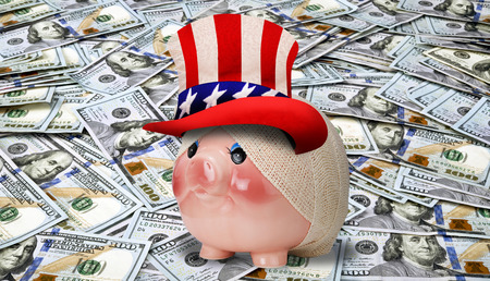 Sick piggy bank with table full of cash.の写真素材