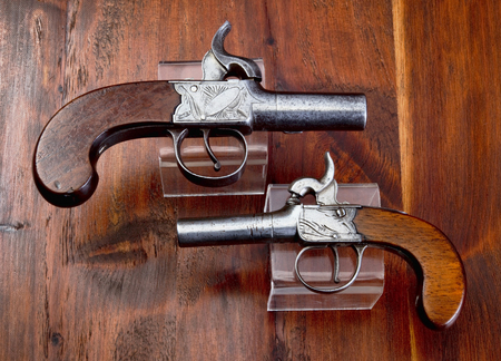 Small antique English percusion muff pistols made around 1840 .の写真素材
