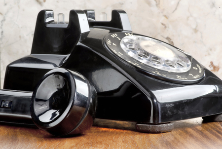Old style black rotary telephone.