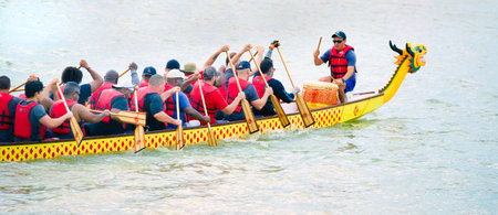 Arlington,Texas - June 15,2019 - Dragon boat race at Lake Viridian. Showing one of the Dragon boats racing at full speed .のeditorial素材