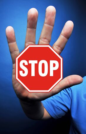 Crazy hand with stop sign.の写真素材