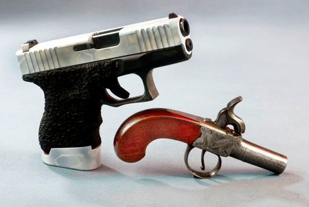 Old school and new school pistols on whiteの写真素材