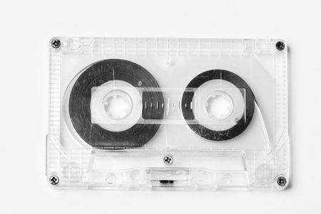 Old plastic audio cassette isolated on whiteの写真素材