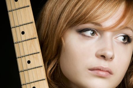 Portrait of a beautiful red haired girl on black backgroundの写真素材