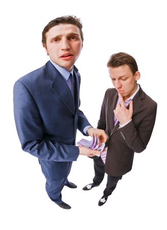 Two young businessmen with lots of cash on white backgroundの写真素材