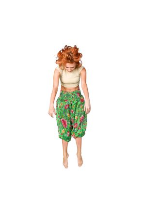 Fit red haired girl isolated on white backgroundの写真素材