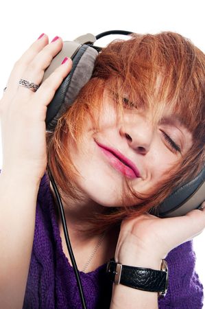 Beautiful girl listening to the music isolated on whiteの写真素材