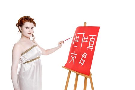 Girl drawing on red canvas isolated on white backgroundの写真素材