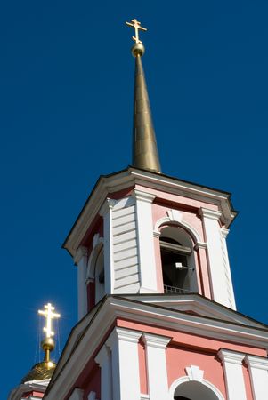 Church towers with a cross shining in the sunlightの写真素材