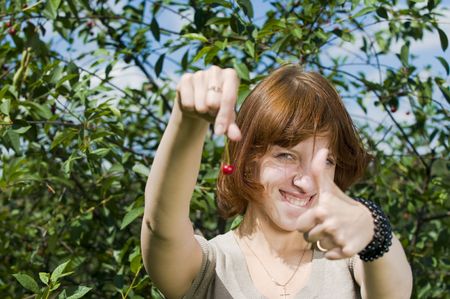 Young red haired girl in a green parkの写真素材