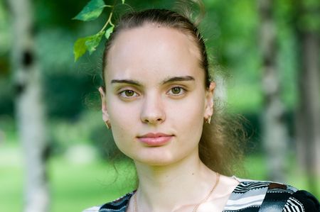 Portrait of a girl in a green parkの写真素材