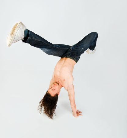 Young man performing a handstand on white backgroundの写真素材