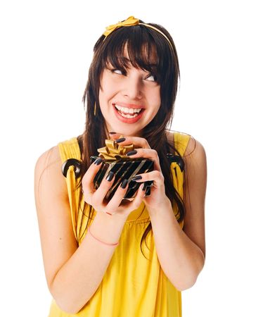 Girl wearing yellow dress with a gift box on whiteの写真素材
