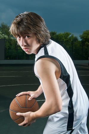 Teenage basketball player holding the ball in "triple threat" positionの写真素材