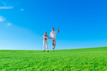 Happy excited couple jumping togetherの写真素材