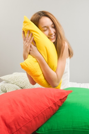 Beautiful young woman in bedの写真素材