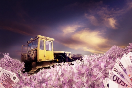 Bulldozer with piles of moneyの写真素材