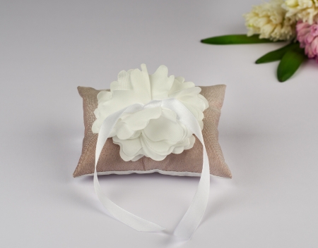 Brown pillow for wedding rings with flowerの写真素材