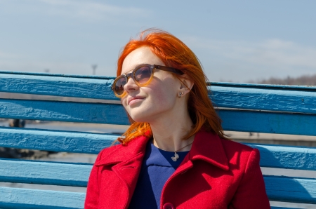 Red woman enjoying sunny dayの写真素材