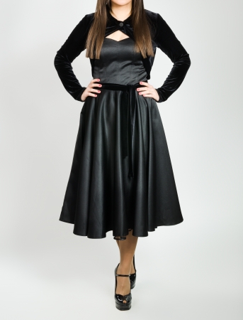 Anonymous woman demonstrating fashion clothes on grayの写真素材