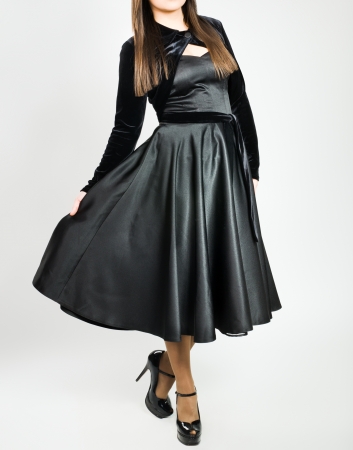 Anonymous woman demonstrating fashion clothes on grayの写真素材