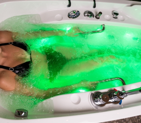 Young woman spends relaxing in the hot tubの写真素材