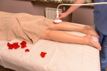 Woman gets therapy treatment at spa salonの写真素材