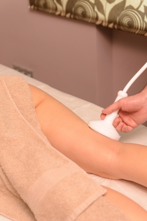Woman gets therapy treatment at spa salonの写真素材
