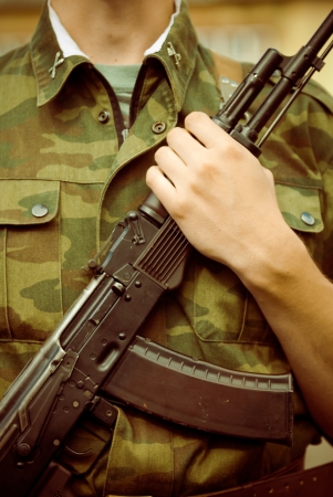 Closeup shot of soldier with AK-47 assault rifleの写真素材