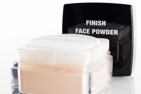 Can with finish face powder on reflective background