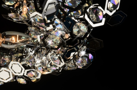 Contemporary glass chandelier fragment isolated over black backgroundの写真素材