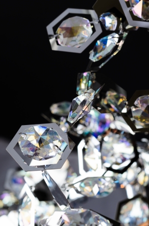 Contemporary glass chandelier fragment isolated over black backgroundの写真素材