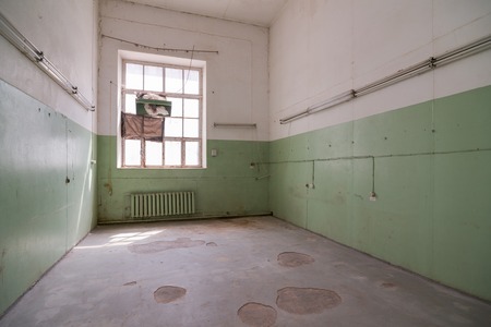 Vacant abandoned office room in old buildingの写真素材