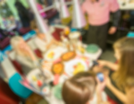 People hanging out at bar party blur background with bokehの写真素材