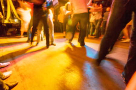 People dancing at the party abstract blur background with bokehの写真素材