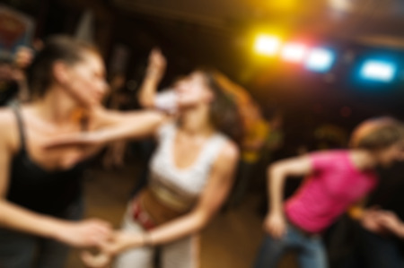 People dancing at the party abstract blur background with bokehの写真素材